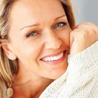 A woman in a cable-knit sweater